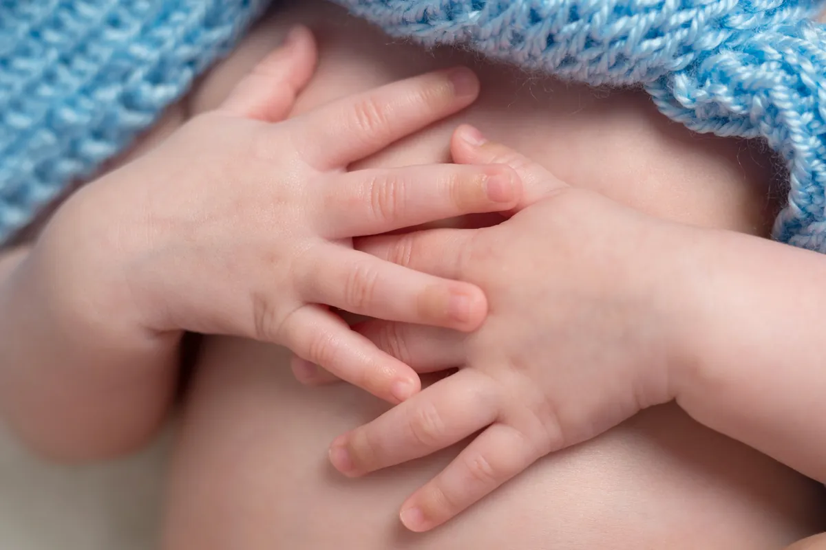 When do babies stop clenching their fists?