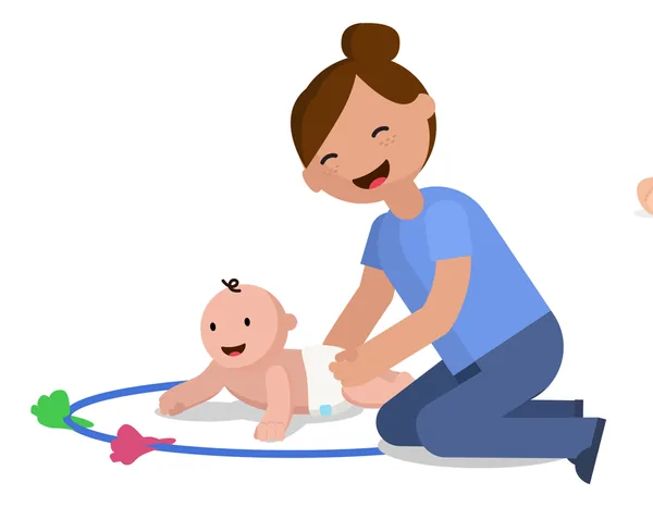 A parent kneeling on the floor, playing with their smiling baby